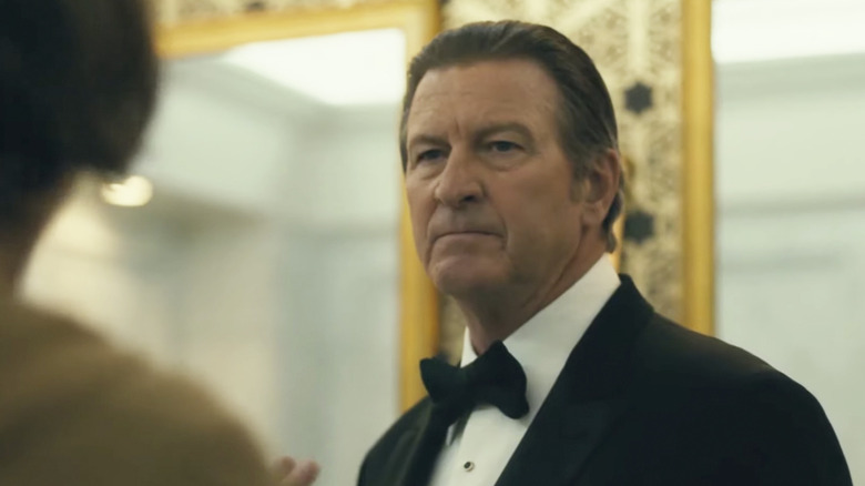 Brett Cullen as Thomas Wayne wearing a black tuxedo in a bathroom with gold mirrors behind him in Joker