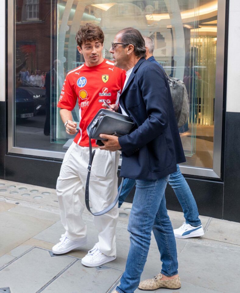 Charles Leclerc talking to someone while leaving a store