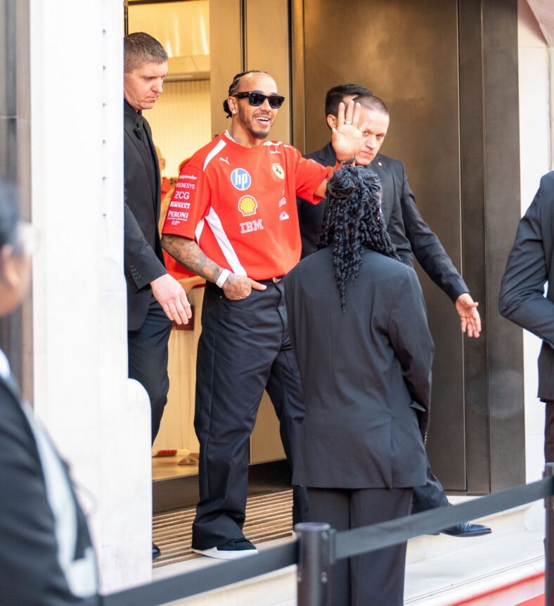 Lewis Hamilton waves to fans while leaving Ferrari store