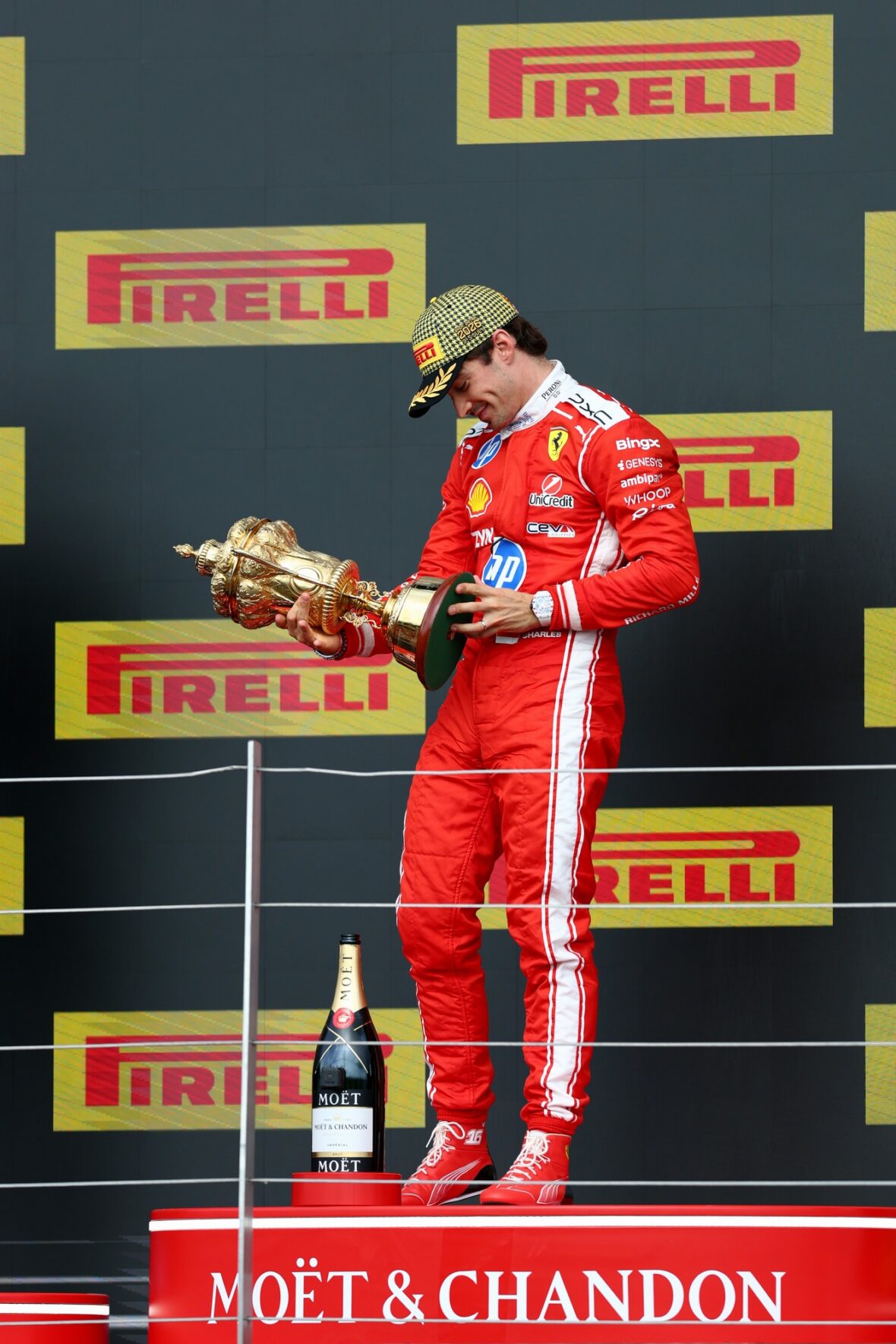 Charles Leclerc holds his first-place trophy at the British Grand Prix