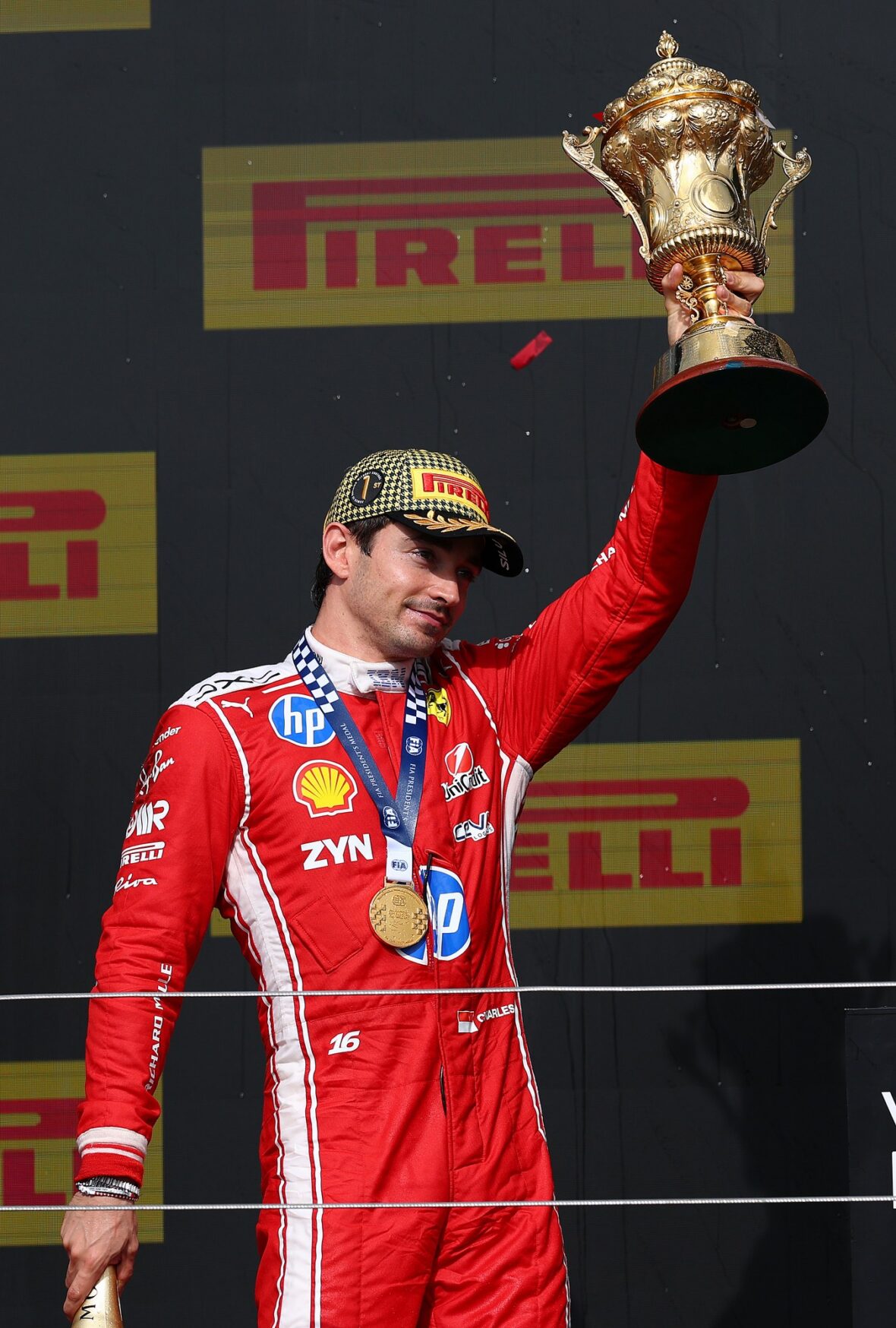 Charles Leclerc holds his first-place trophy at the British Grand Prix