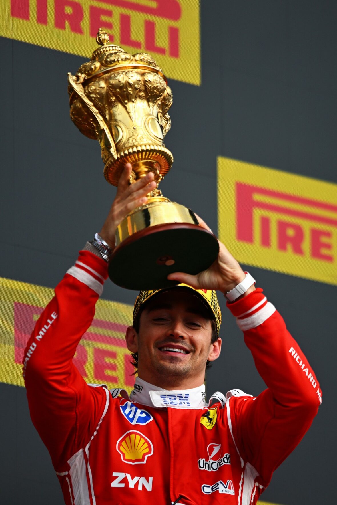 Charles Leclerc holds his first-place trophy at the British Grand Prix