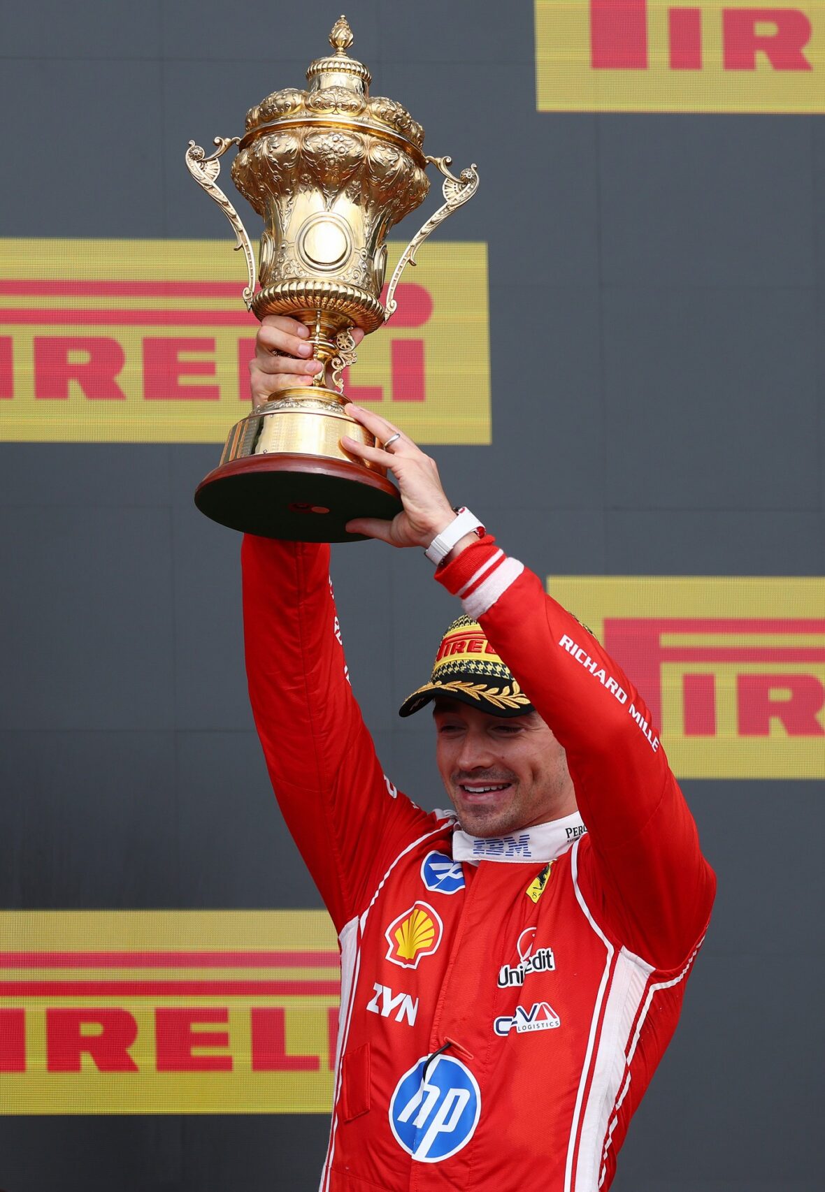 Charles Leclerc holds his first-place trophy at the British Grand Prix