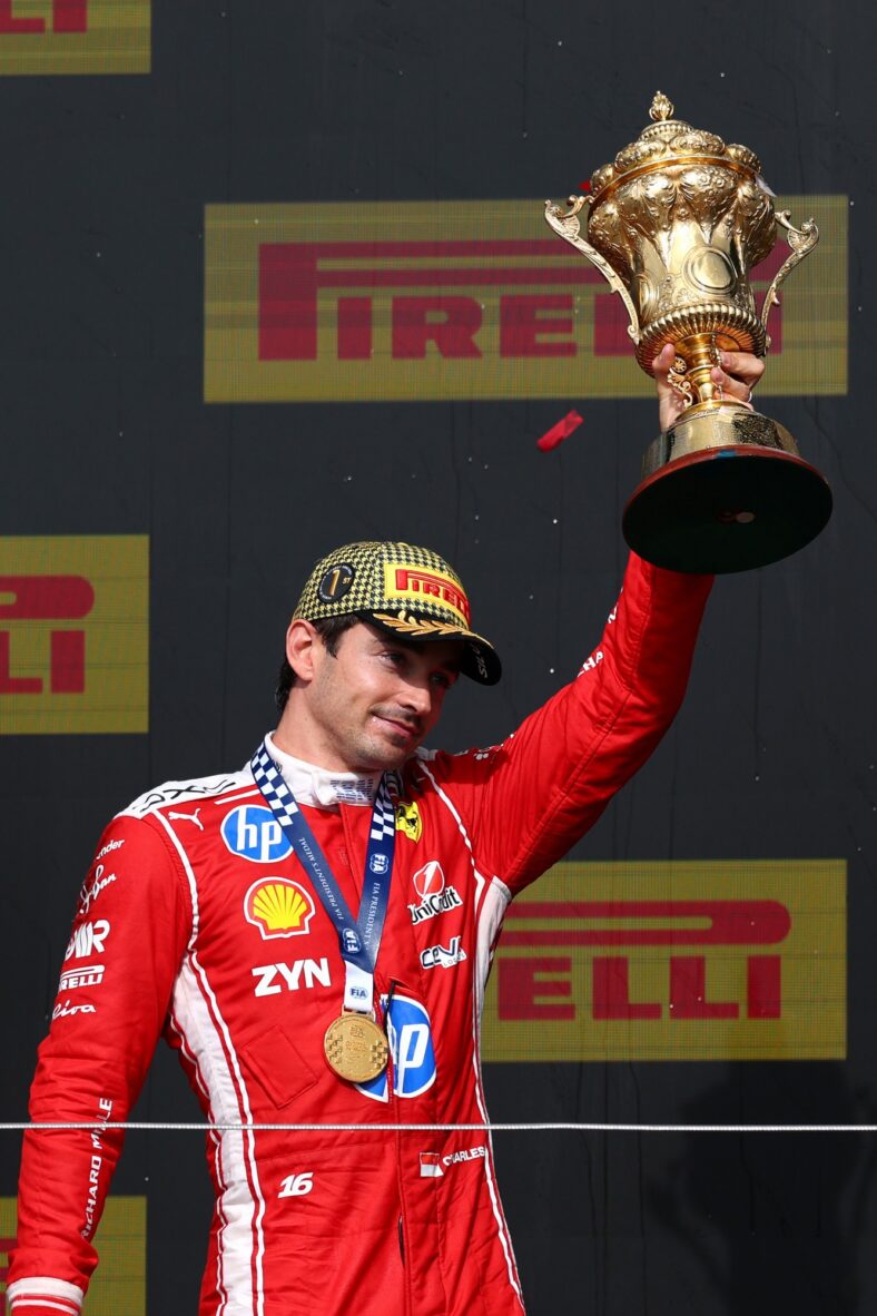 Charles Leclerc holds his first-place trophy at the British Grand Prix