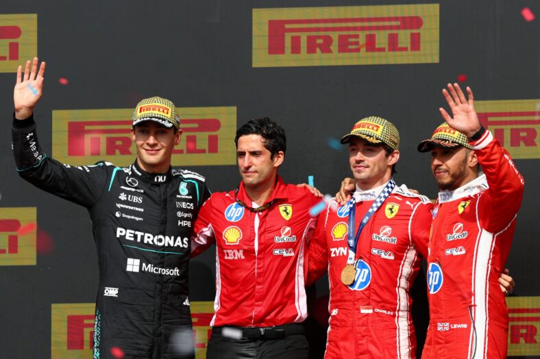 George Russell, Bryan Bozzi, Charles Leclerc and Lewis Hamilton on the podium after the British Grand Prix