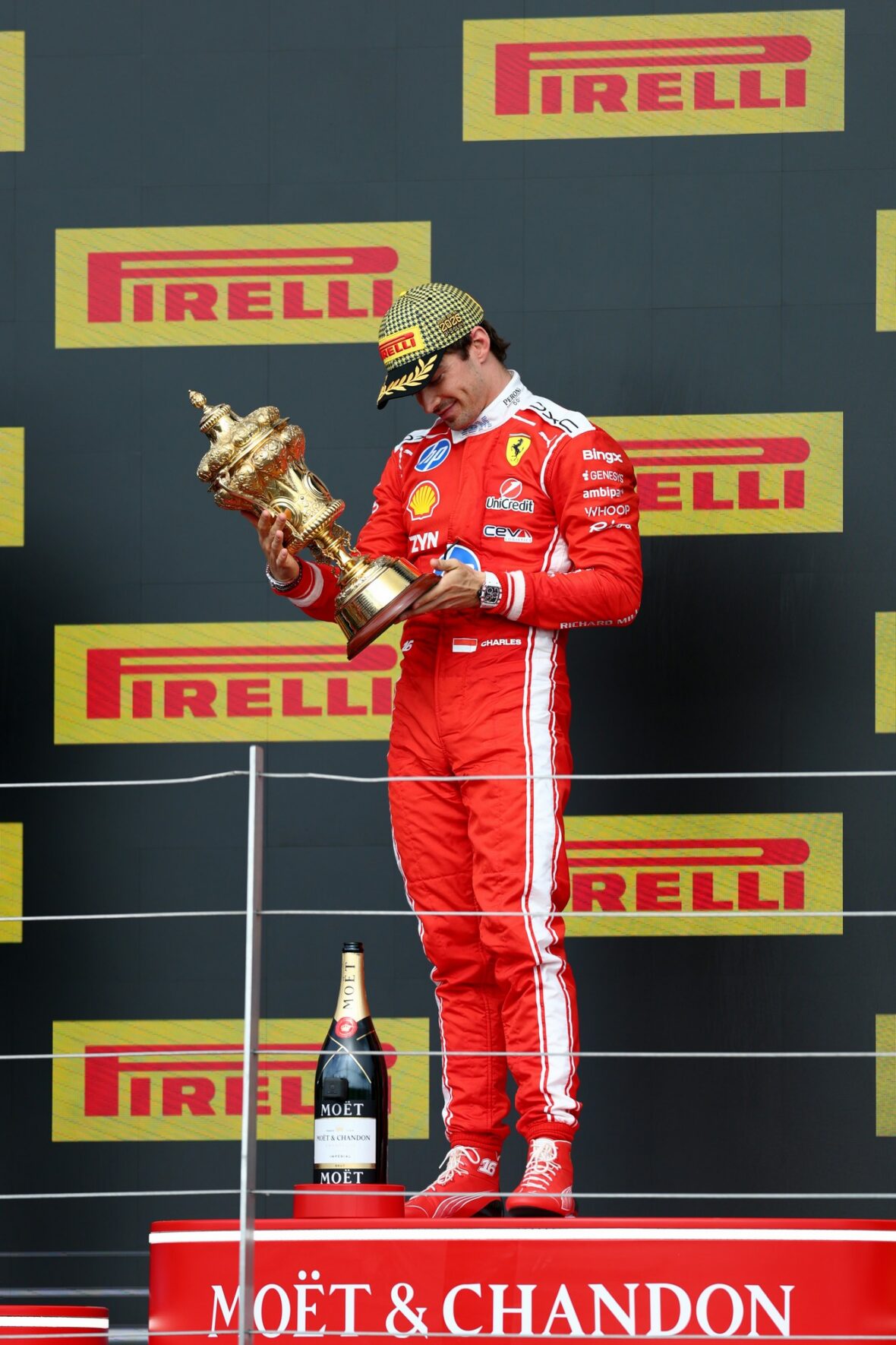 Charles Leclerc holds his first-place trophy at the British Grand Prix