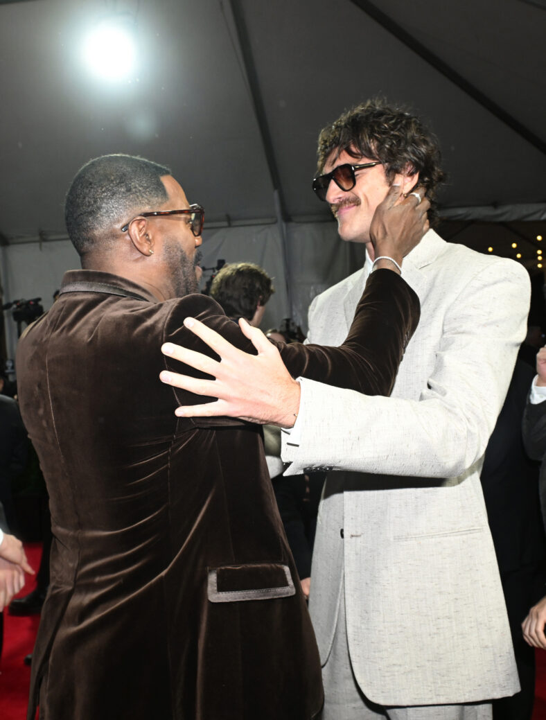 Colman Domingo and Jacob Elordi greet one another at a red carpet event.