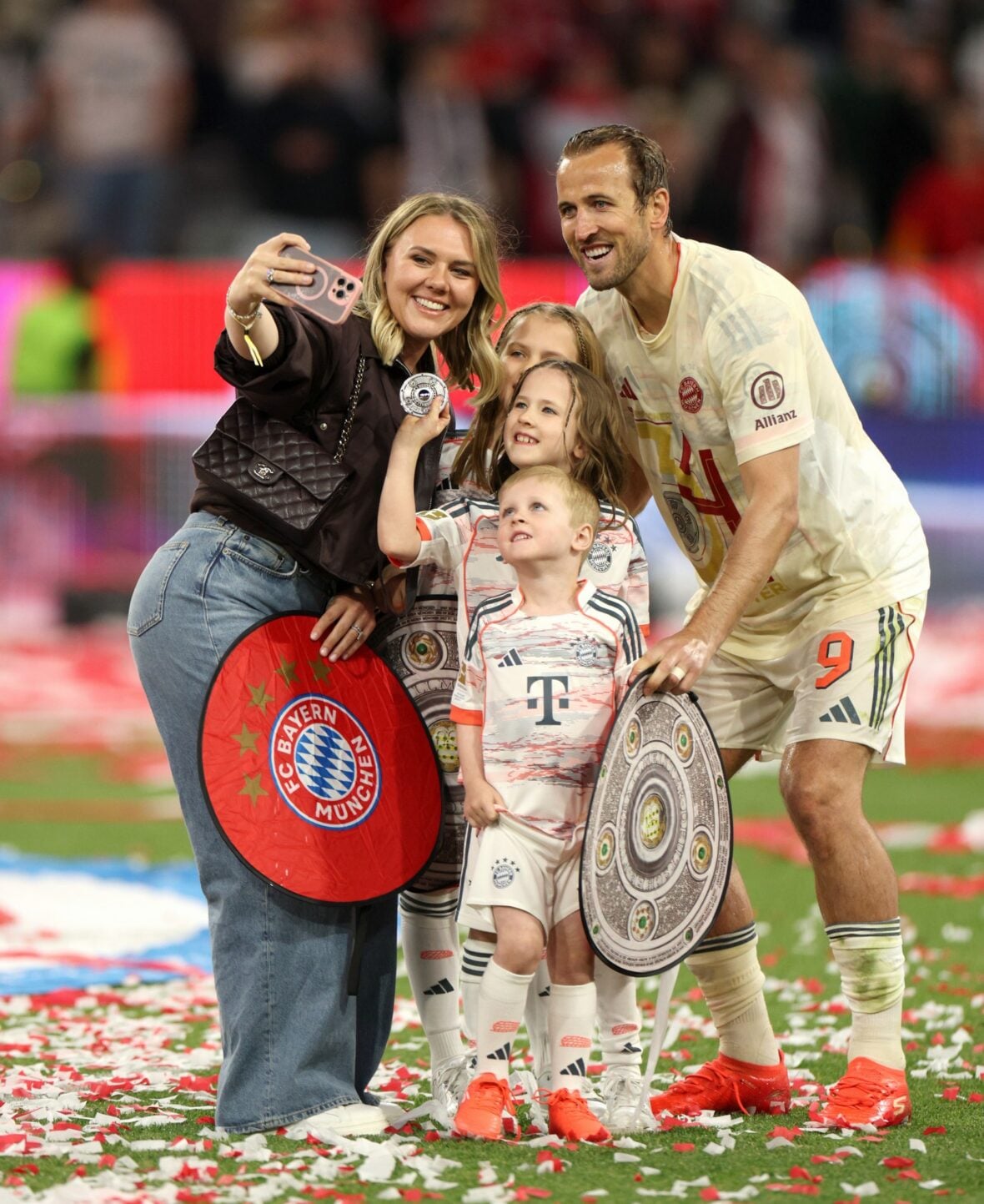 Harry and Katie Kane with their kids at the Bundesliga match