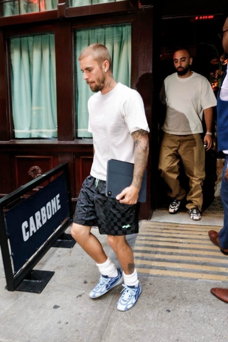 Justin Bieber in a white shirt, checkered pants, and sneakers in NYC.