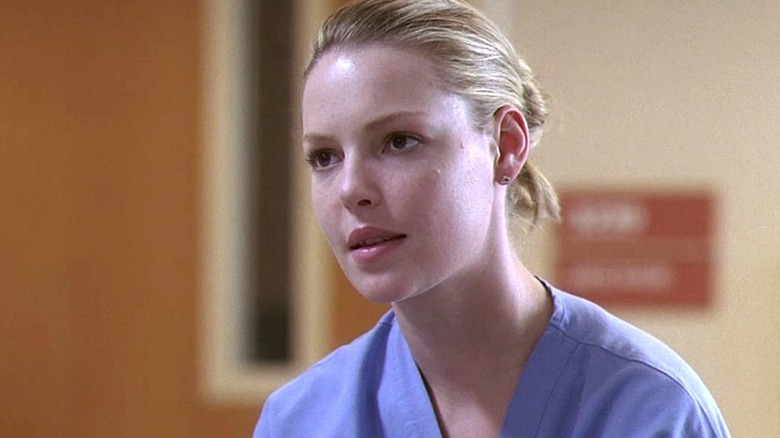 Dr. Izzie Stevens in blue scrubs and her blonde hair tied back in Grey's Anatomy