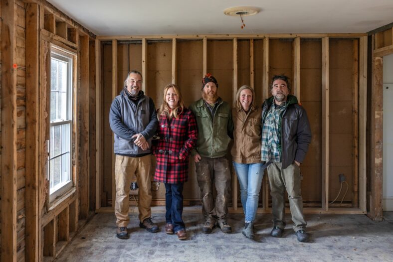 Maine Cabin Masters: All In pose in the bed and breakfast