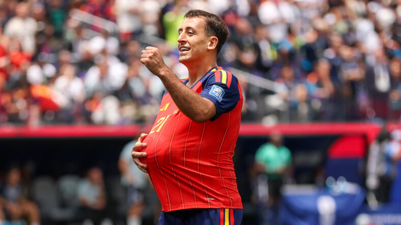 Mikel Oyarzabal with a soccer ball in his shirt to represent a pregnant belly mid-match