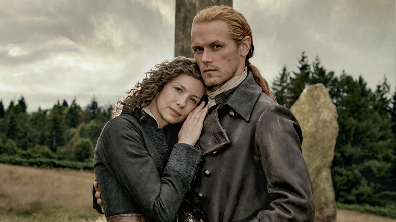 Catriona Balfe as Claire and Sam Heughan as Jamie in leather period attire in 