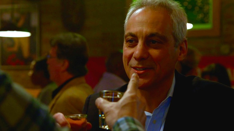 Rahm Emanuel with shot glass in hand at Molly's bar, toasting