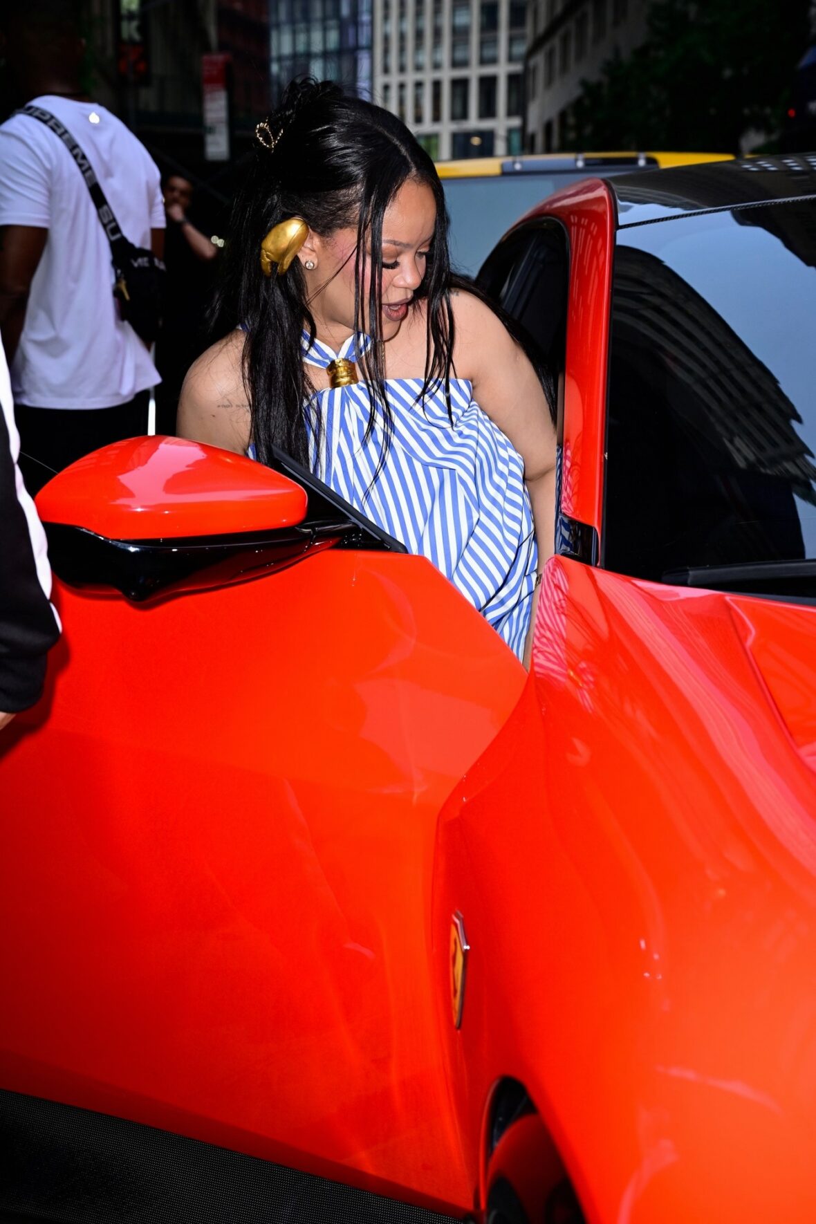 Rihanna gets into the passenger seat of a car while out in NYC