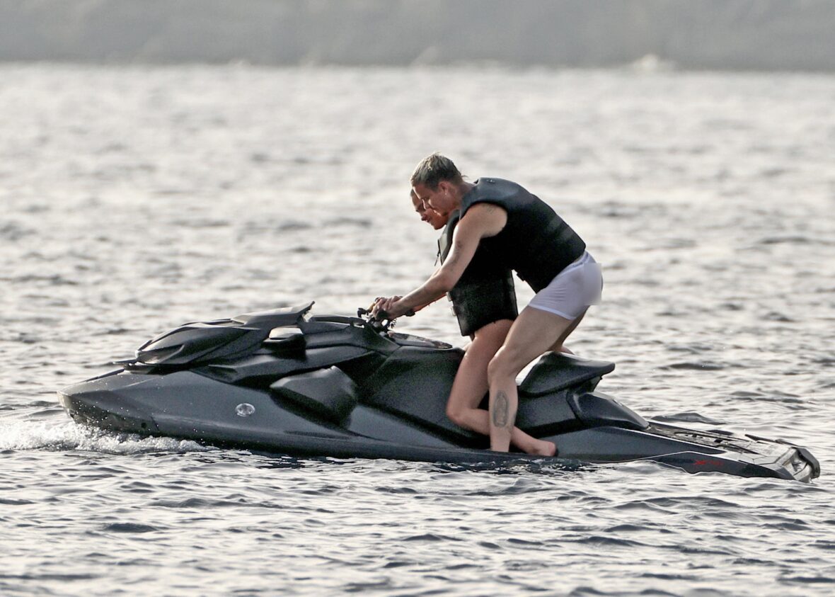 Romeo Beckham and Kim Turnbull on a jetski in the water