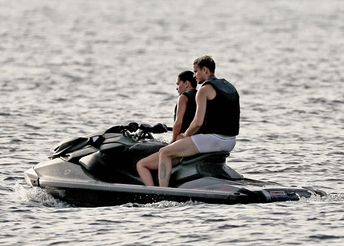 Romeo Beckham and Kim Turnbull on a jetski in the water