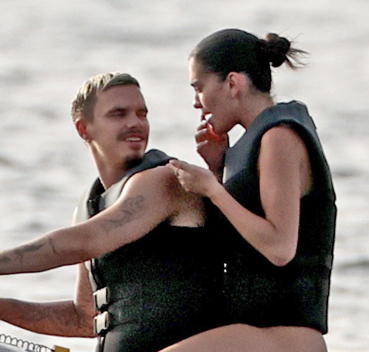 Romeo Beckham and Kim Turnbull on a jetski in the water
