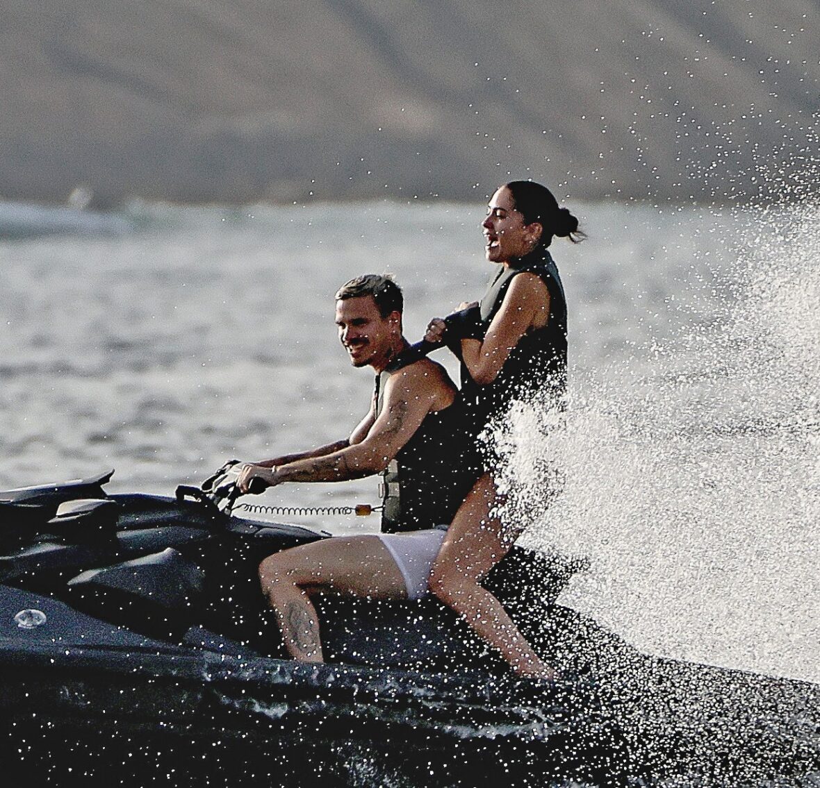 Romeo Beckham and Kim Turnbull on a jetski in the water