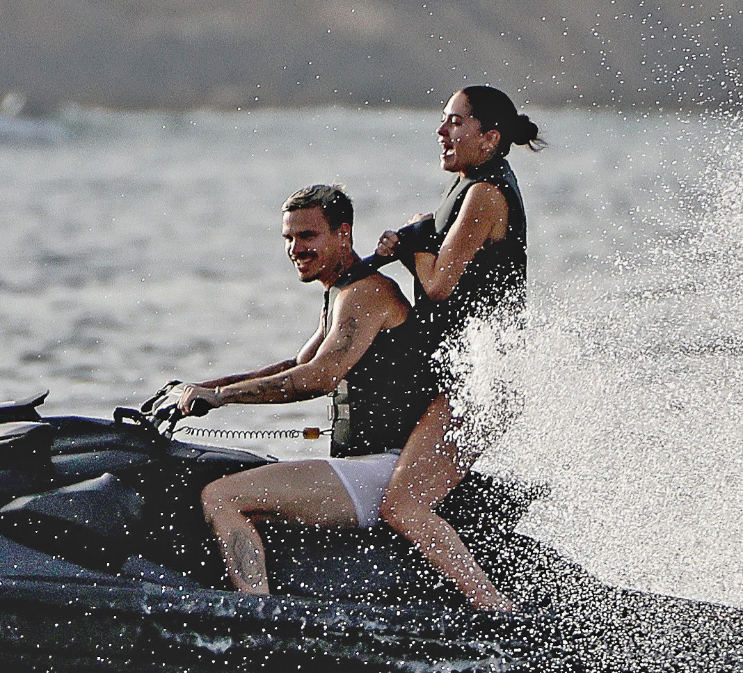 Romeo Beckham and Kim Turnbull on a jetski in the water