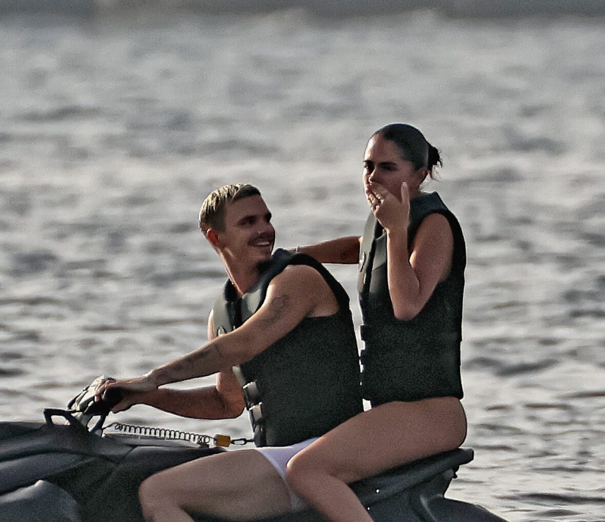 Romeo Beckham and Kim Turnbull on a jetski in the water
