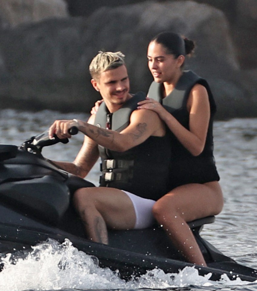 Romeo Beckham and Kim Turnbull on a jetski in the water