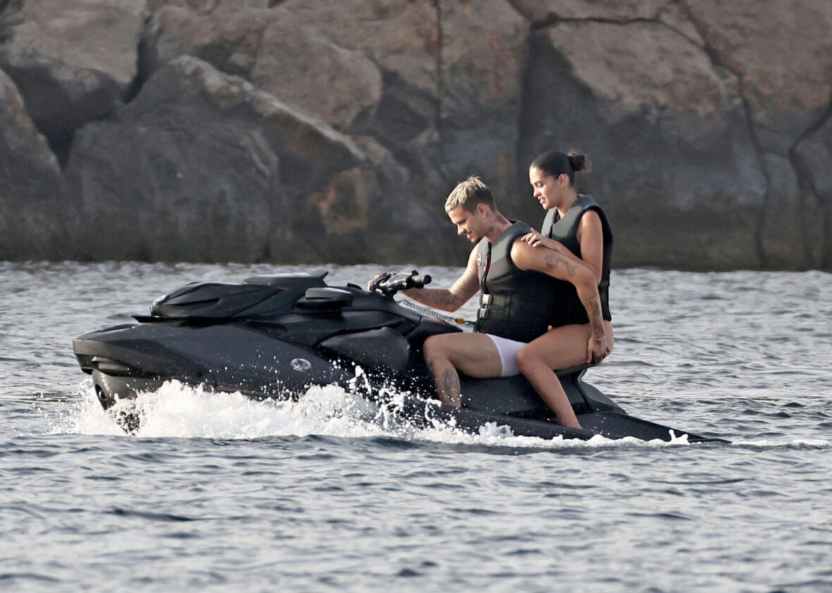 Romeo Beckham and Kim Turnbull on a jetski in the water