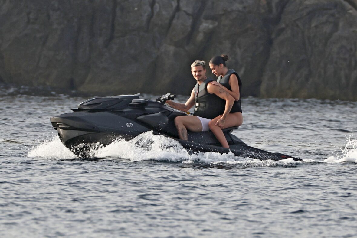 Romeo Beckham and Kim Turnbull on a jetski in the water