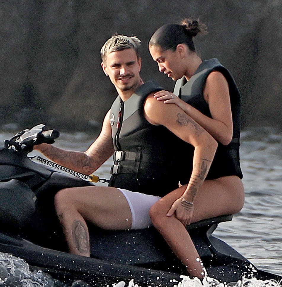 Romeo Beckham and Kim Turnbull on a jetski in the water