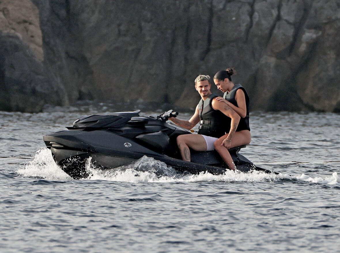 Romeo Beckham and Kim Turnbull on a jetski in the water