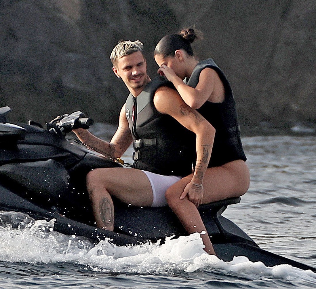Romeo Beckham and Kim Turnbull on a jetski in the water