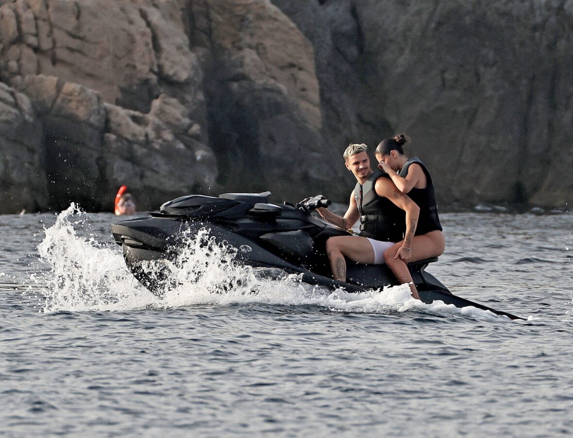 Romeo Beckham and Kim Turnbull on a jetski in the water