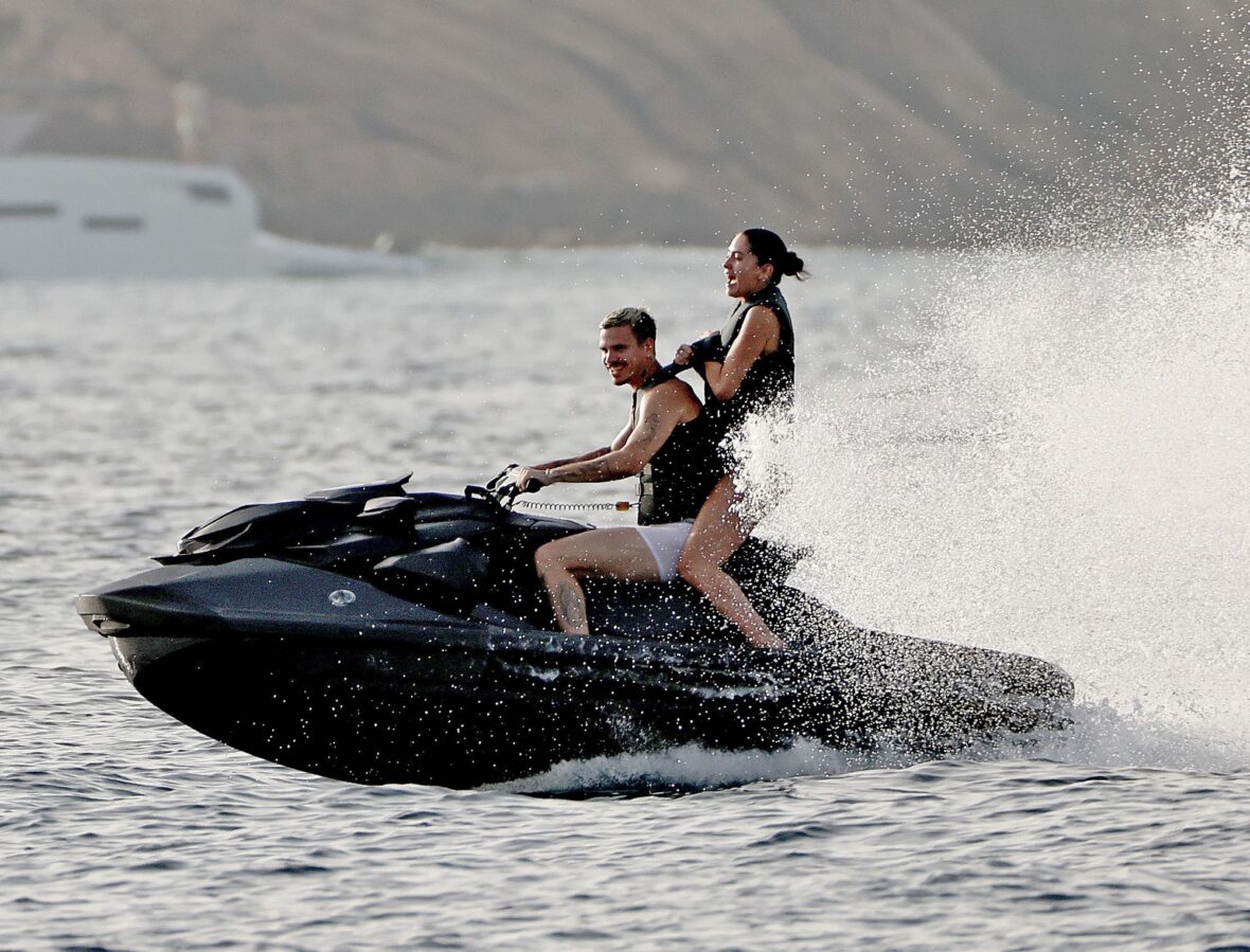 Romeo Beckham and Kim Turnbull on a jetski in the water