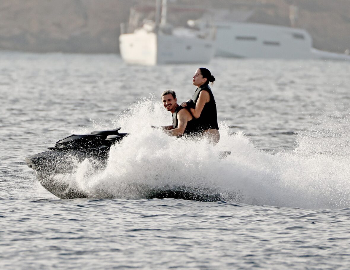 Romeo Beckham and Kim Turnbull on a jetski in the water