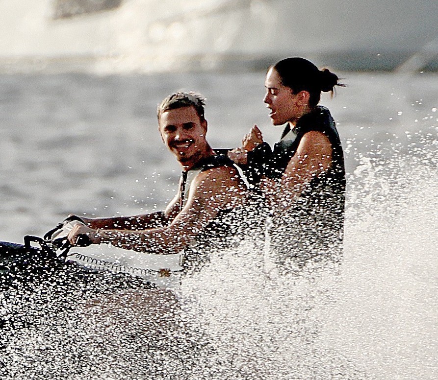 Romeo Beckham and Kim Turnbull on a jetski in the water