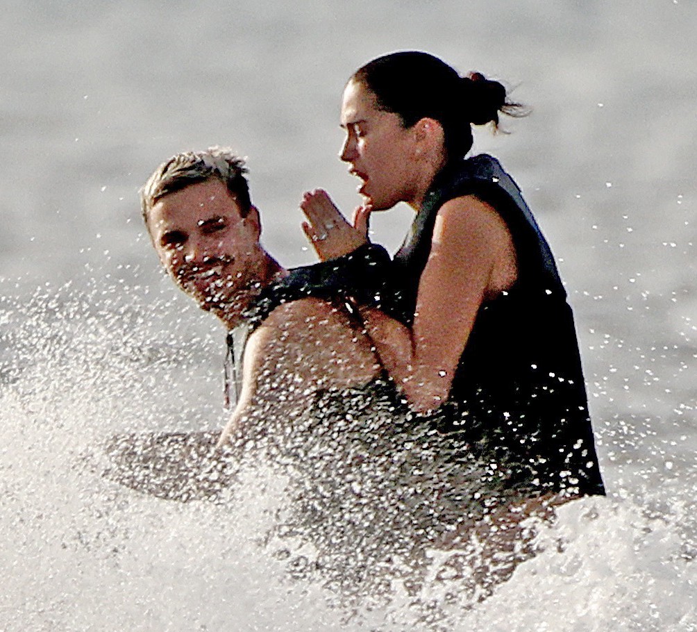Romeo Beckham and Kim Turnbull on a jetski in the water