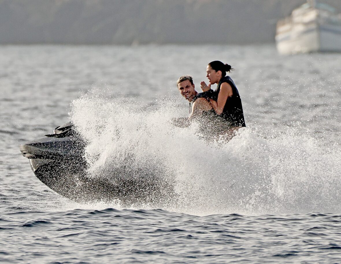Romeo Beckham and Kim Turnbull on a jetski in the water