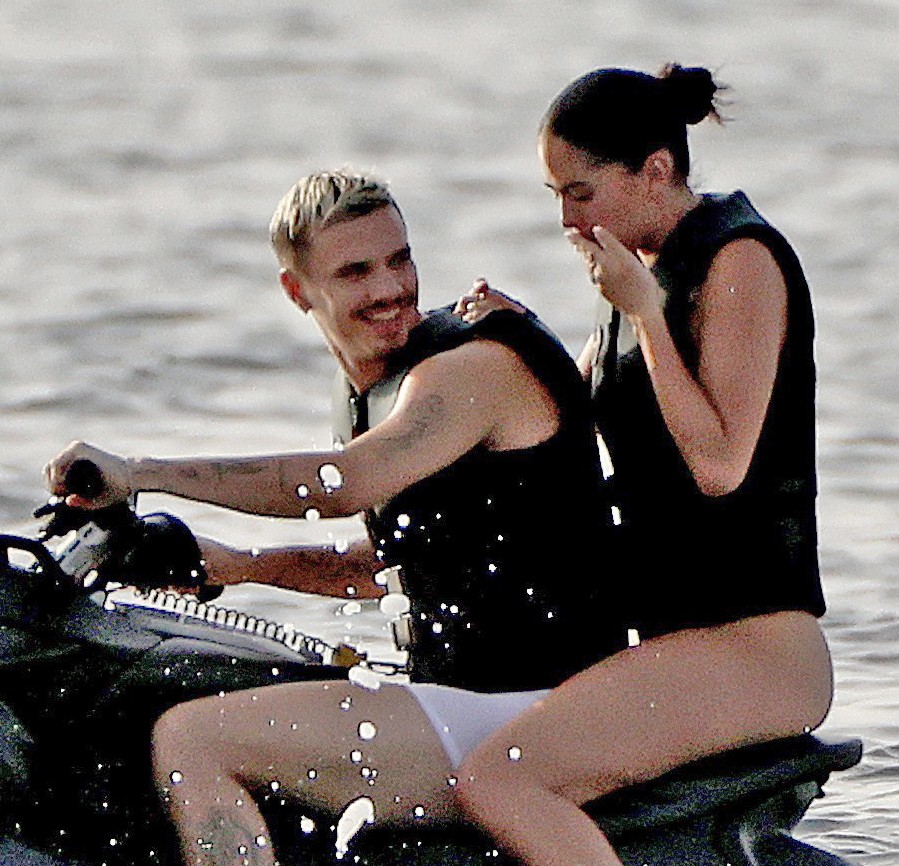 Romeo Beckham and Kim Turnbull on a jetski in the water