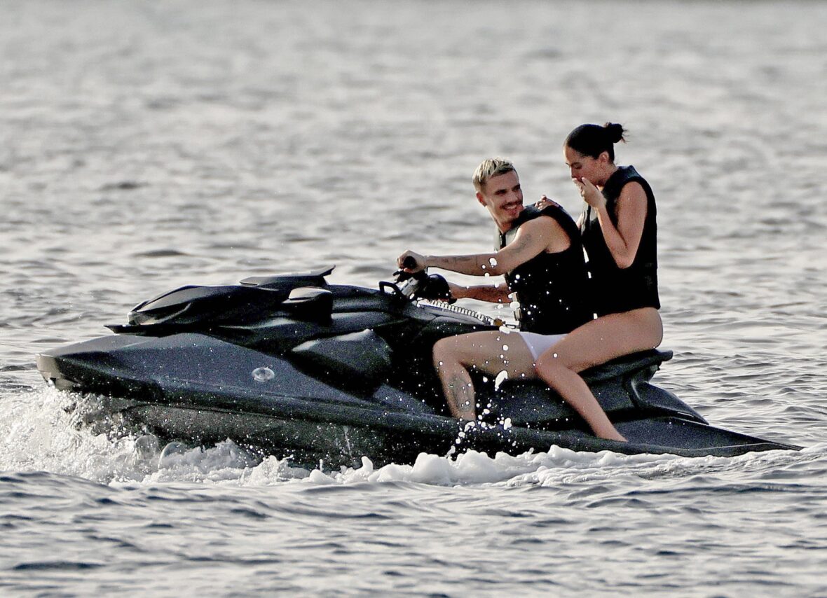 Romeo Beckham and Kim Turnbull on a jetski in the water