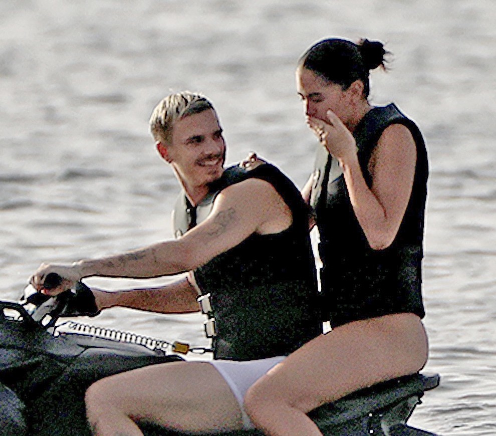 Romeo Beckham and Kim Turnbull on a jetski in the water