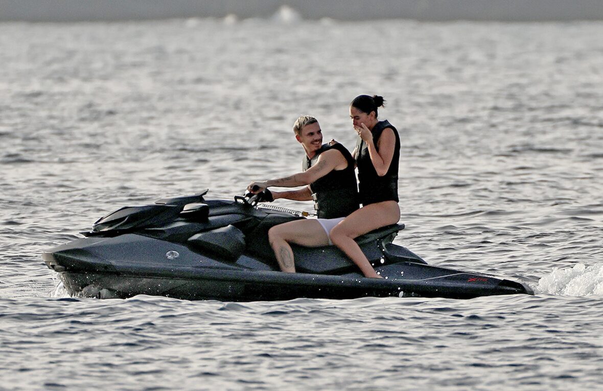 Romeo Beckham and Kim Turnbull on a jetski in the water