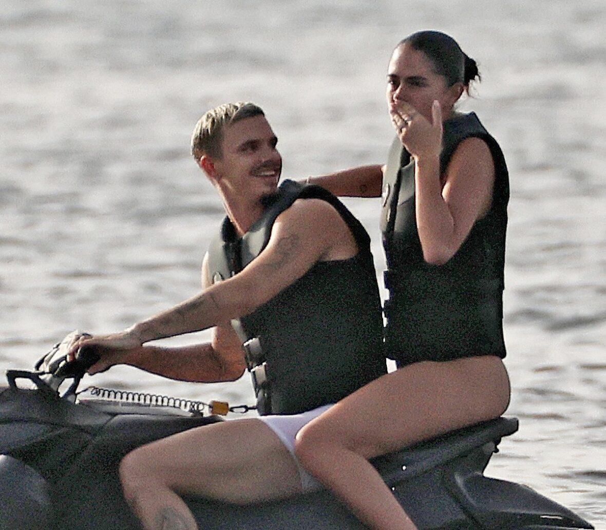 Romeo Beckham and Kim Turnbull on a jetski in the water
