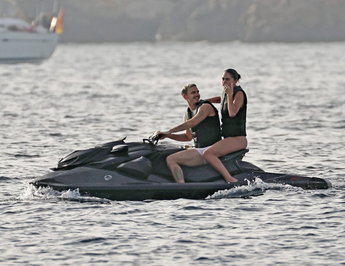 Romeo Beckham and Kim Turnbull on a jetski in the water