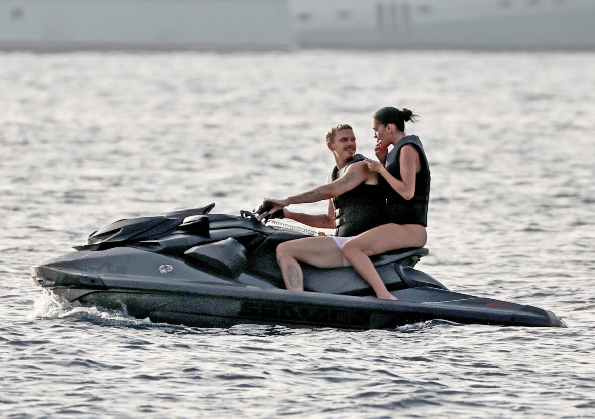 Romeo Beckham and Kim Turnbull on a jetski in the water