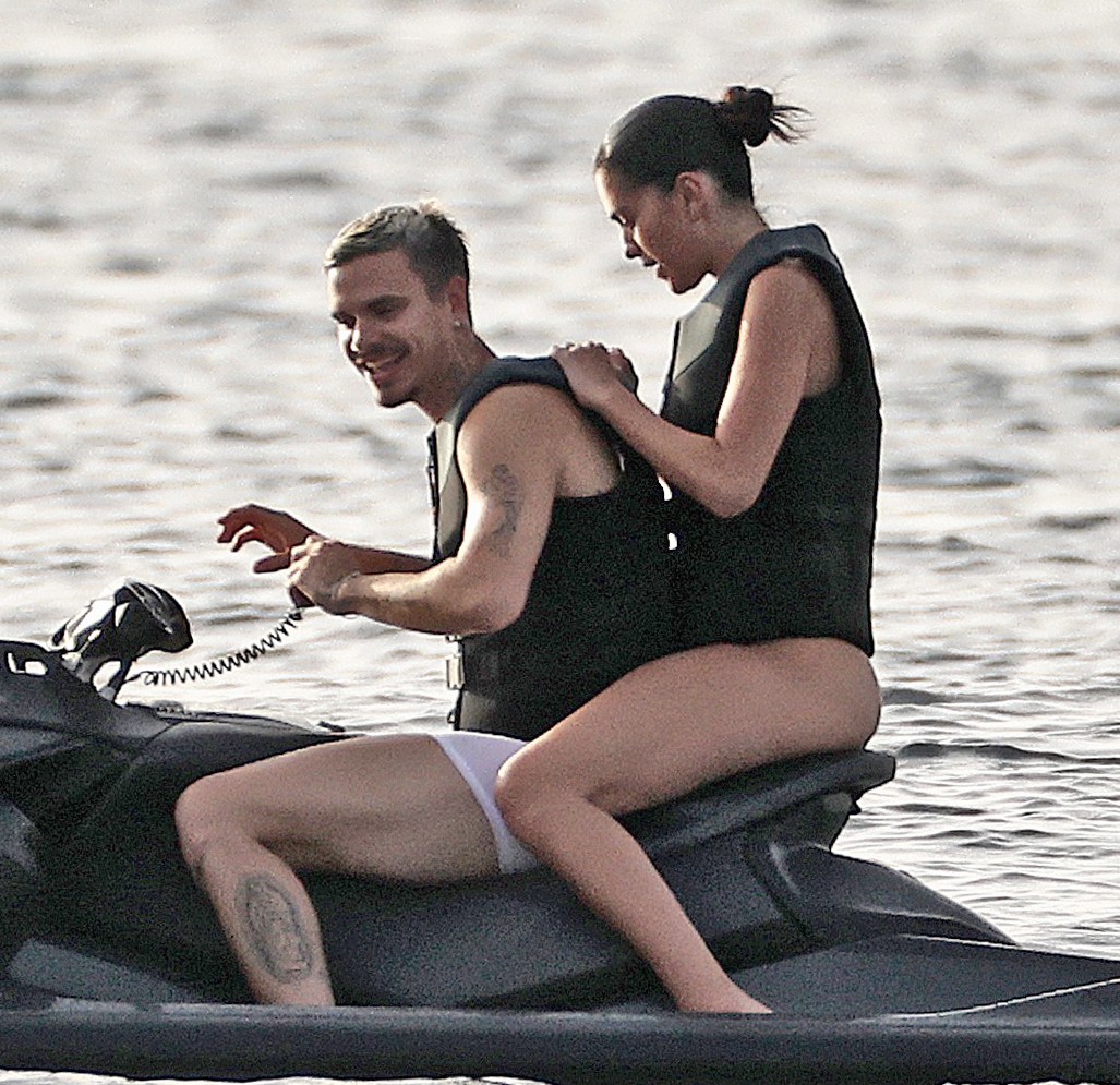 Romeo Beckham and Kim Turnbull on a jetski in the water