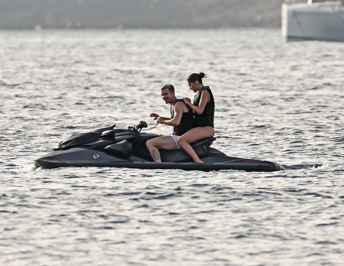 Romeo Beckham and Kim Turnbull on a jetski in the water