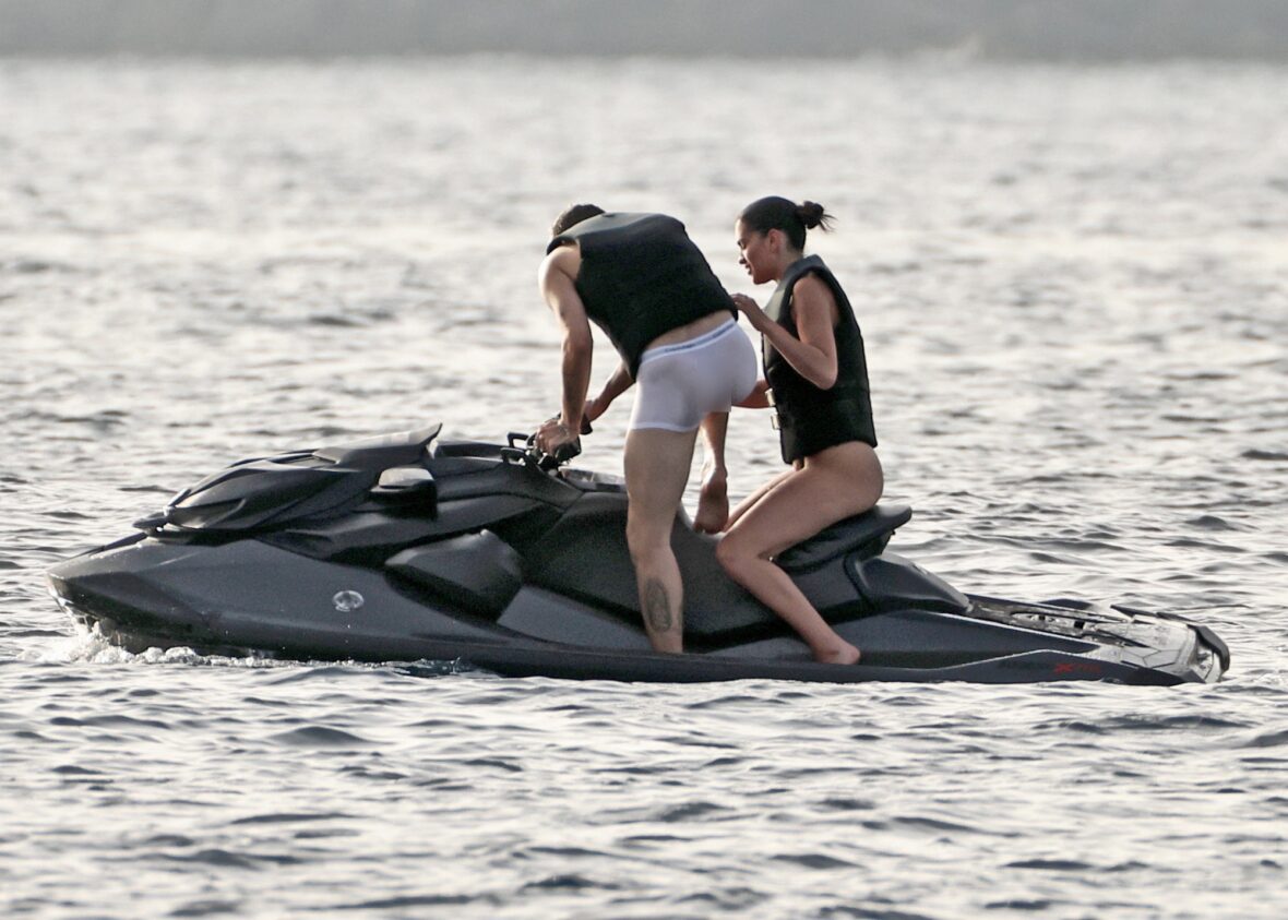 Romeo Beckham and Kim Turnbull on a jetski in the water