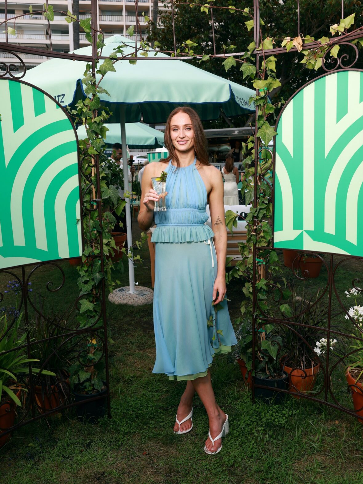 Sophie Turner wears chiffon wrap top and skirt to St. Germain's pop-up in Cannes
