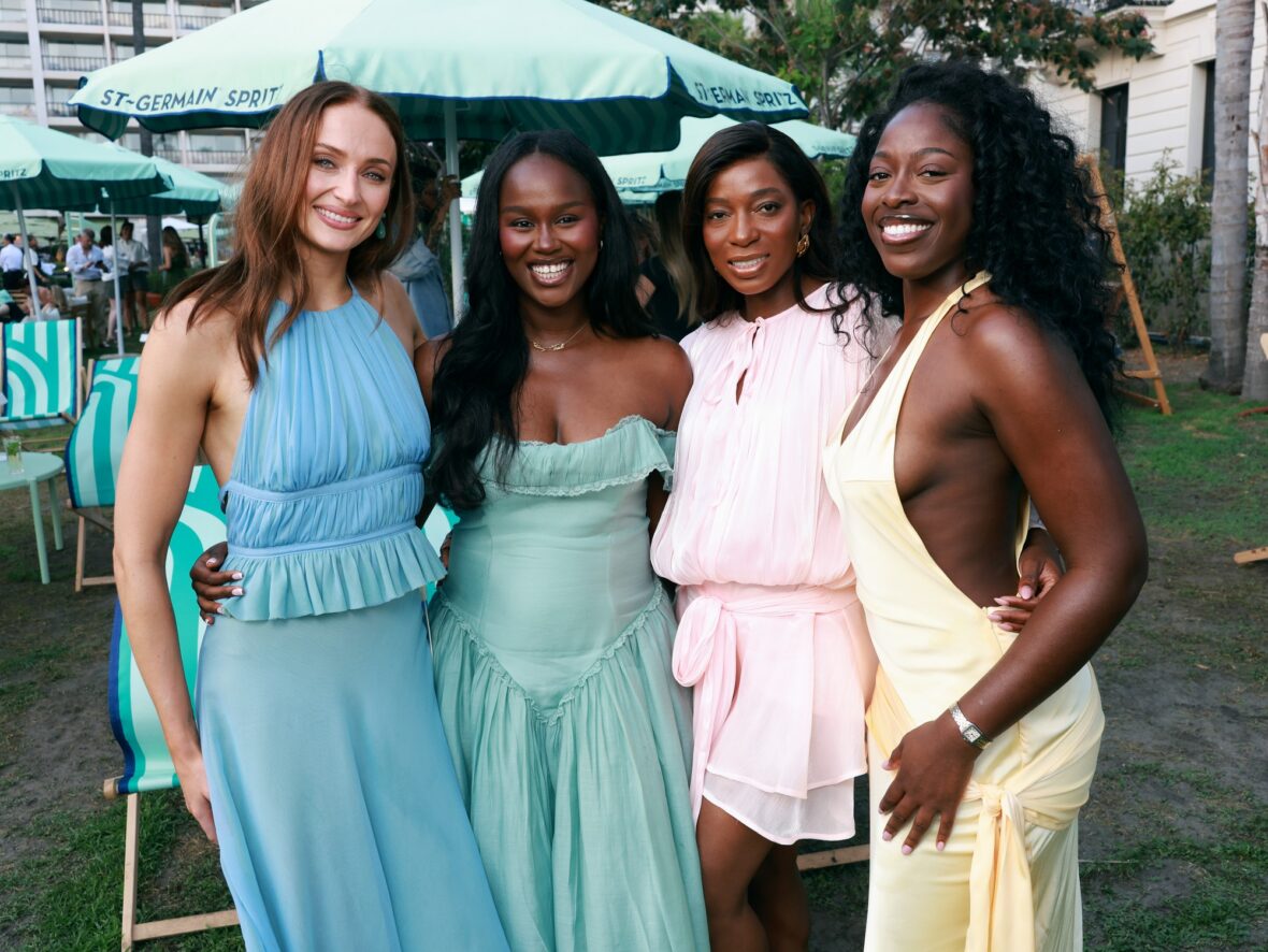 Sophie Turner wears chiffon wrap top and skirt while posing with guests at St. Germain's pop-up in Cannes