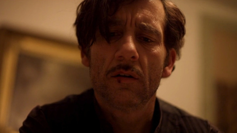 A close-up of John Thackery looking down with a busted lip